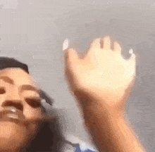 a close up of a person 's hand reaching up towards the sky .