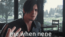 a man in a leather jacket says me when nene in front of a window