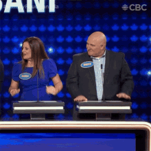 a man and a woman are on a game show and the man has a name tag that says angelo