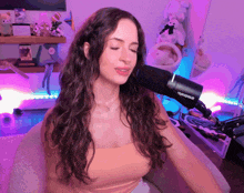 a woman singing into a shure microphone in a room