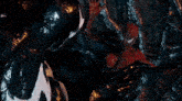 a spider man is being eaten by a venom monster
