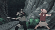 a girl in a pink shirt is kicking a man