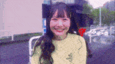 a girl wearing a yellow shirt that says mik on it smiles