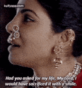 a close up of a woman 's face with a nose ring and earrings and a quote .