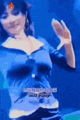 a woman in a blue top is dancing in front of a sign that says pop popy