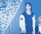 a girl wearing a baseball jacket with the number 22 on it