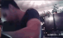 a blurry picture of a man holding a woman 's arm