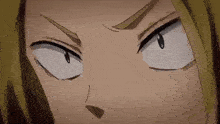 a close up of a person 's face with their eyes closed and a serious look on their face .