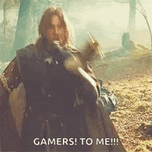 a man is holding a sword and shield in the woods and says `` gamers to me '' .