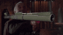 a man is holding a gun in front of a jar jar studios sign