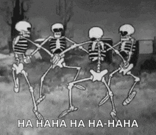 a group of skeletons are holding hands and dancing in a cemetery .