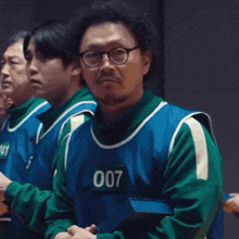 a man in a green and blue uniform with the number 007 on his chest