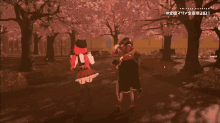 a couple of people walking in a park with cherry blossom trees behind them