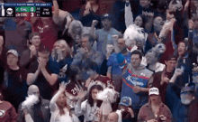 a crowd of people watching a hockey game with a scoreboard that says tnt