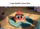 a red angry bird with big eyes is sitting on a green mat .