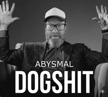 a black and white photo of a man with the words abysmal dogshit on the bottom
