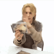 a man is holding a cd that says ' a ' on it