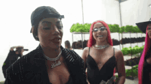 a woman wearing a necklace that says ' labella ' on it stands next to another woman