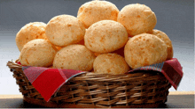 a wicker basket filled with cheese balls on a checkered cloth