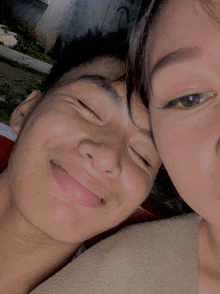 a man and a woman are smiling for the camera