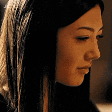 a close up of a woman 's face with the letter j in the lower right corner