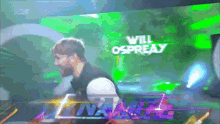 a man is standing in front of a screen that says will ospreay