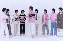 a group of young men are standing in a row with one wearing a shirt that says hype