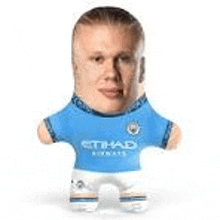 a stuffed soccer player with a big head and a blue shirt .