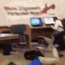 a blurry picture of people sitting at desks with laptops