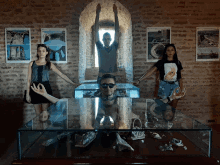 a group of people are posing for a picture in front of a glass table