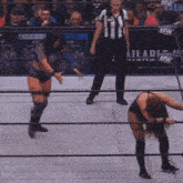 a wrestling match is taking place in front of a sign that says " ash "