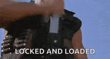 a man in a military uniform is holding a gun with the words `` locked and loaded '' written on it .