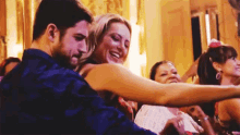 a man and woman are hugging each other in a crowded room