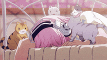 a girl with pink hair and headphones is laying on a bed with cats