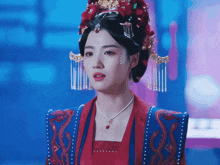 a woman in a red and blue costume with a red necklace
