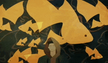 a man in a hooded jacket is surrounded by goldfish