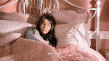 a girl laying in a bed with the words i don 't know above her