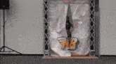 a woman stands behind a sign that says nb on it