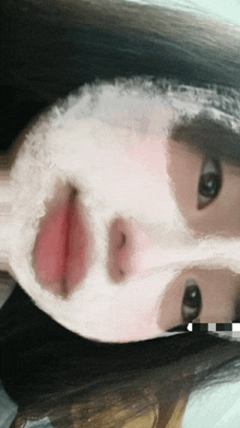 a close up of a person 's face with a white mask on it