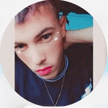 a close up of a man 's face with pink lipstick and snowflakes on his face