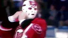 a hockey player wearing a mask with the letter e on it .