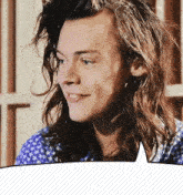 a man with long hair is smiling with a speech bubble behind him