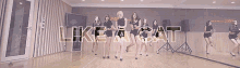 a group of women are dancing in front of a mirror with the words like a cat on the bottom