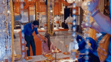 a man and a girl are sitting at a table in a room with candles .