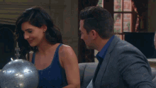 a man and a woman looking at a globe together