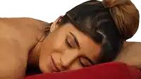 a woman with a bun on her head is laying on a red pillow