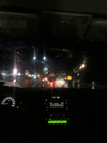 a car is driving down a highway at night and the radio displays the time as 4:20