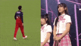 a man walking on a field next to a girl in a plaid skirt .