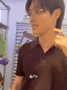 a close up of a man wearing glasses and a polo shirt with a sticker on it that says ' a '