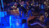 a group of people dancing in a room with a sign that says ufc